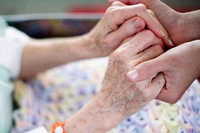 Two hands clasped together, symbolizing care.