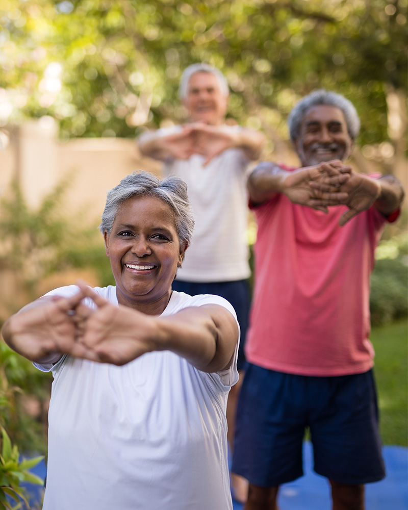 Residents participating in outdoor stretching exercises.