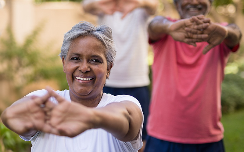 Residents engaging in outdoor stretching exercises.