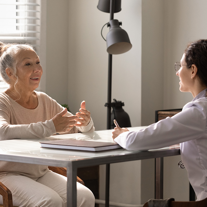 Resident engaging in conversation with staff member.