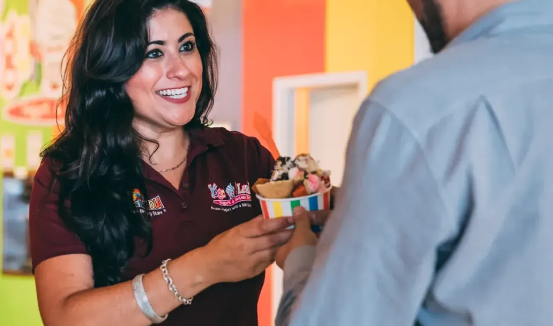 Staff member serving dessert to a resident