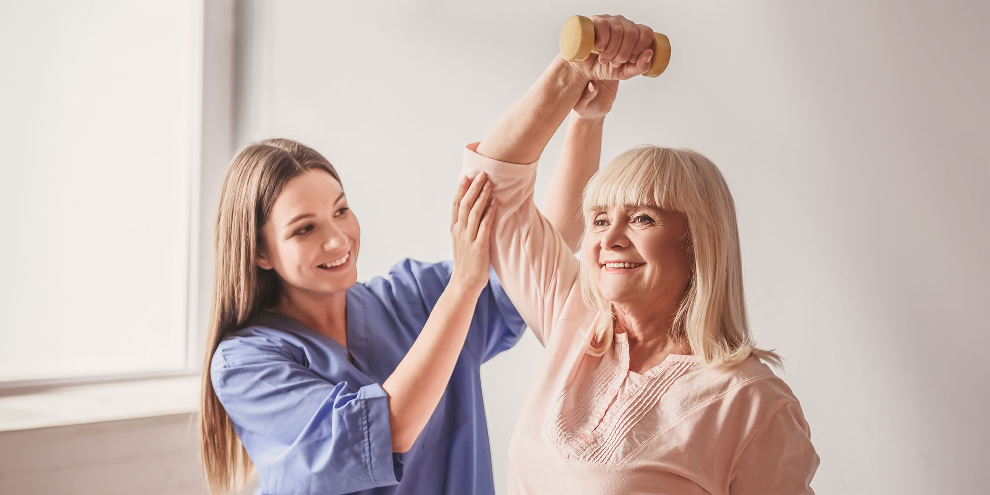 Therapist assisting older adult with exercise.