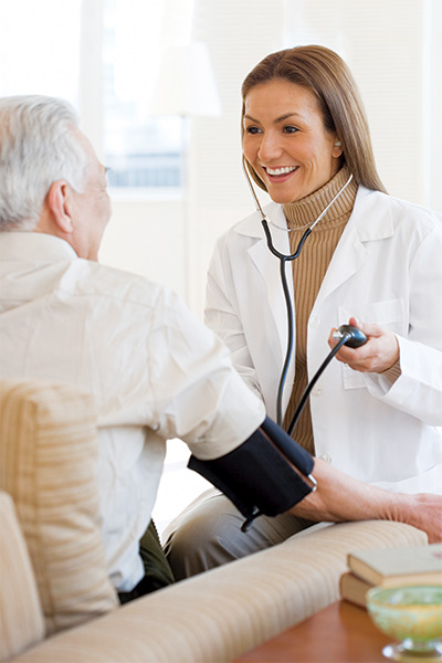 Healthcare professional checking a senior's blood pressure