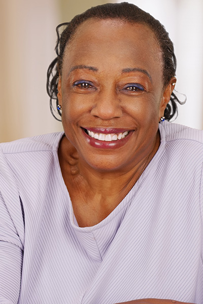 Smiling woman in a light purple top