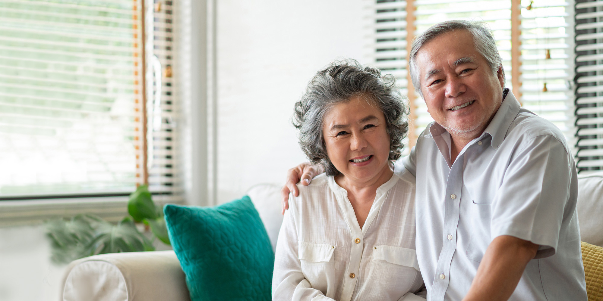 Older couple smiling together in a bright living space