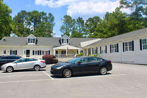 Exterior view of Golden Rose Home with parked cars.