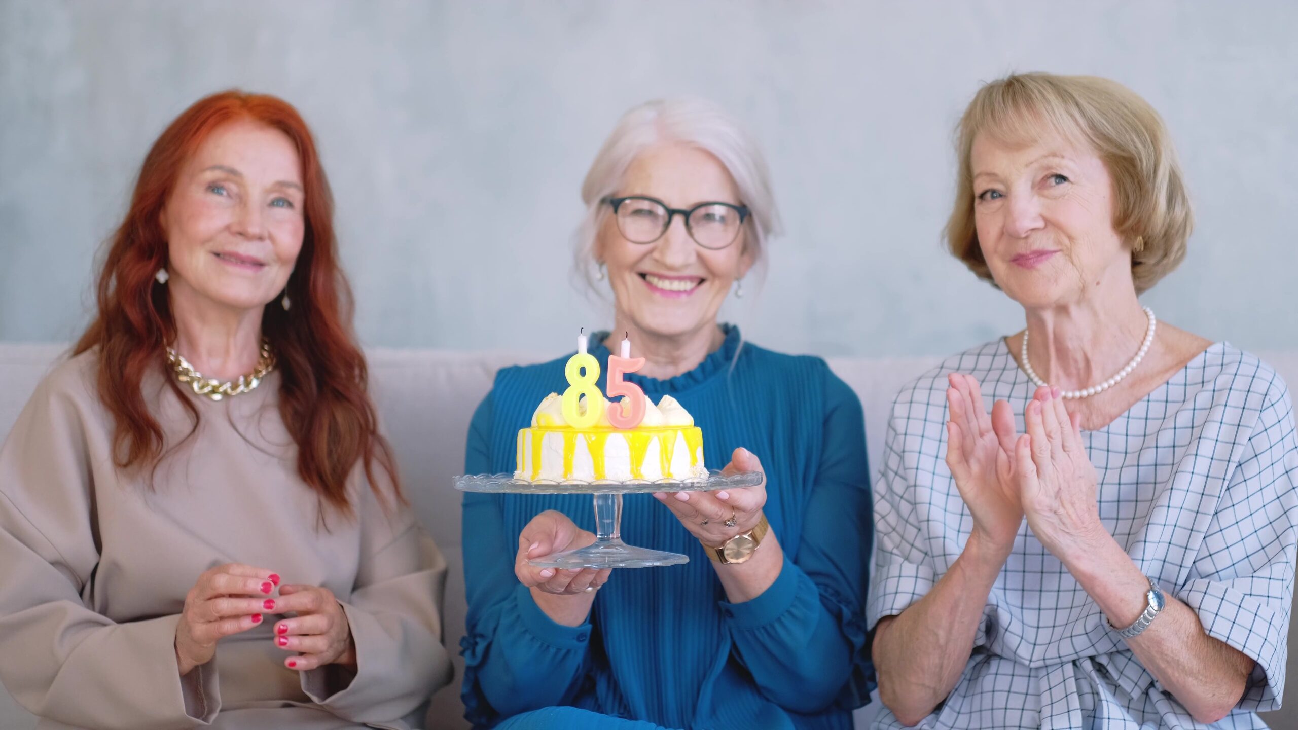 Seniors celebrating an 85th birthday with cake