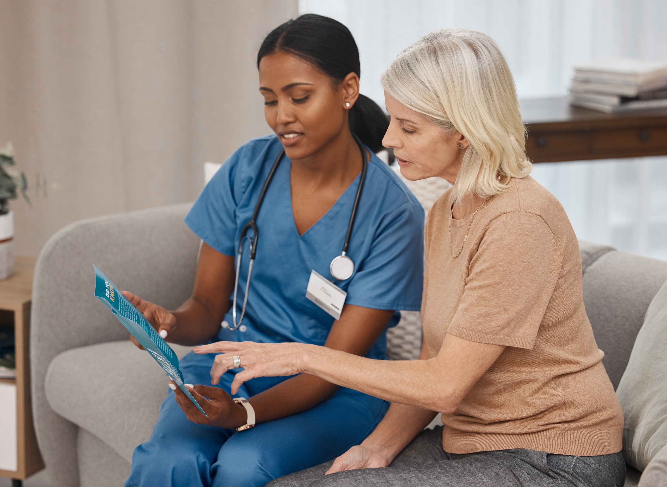 Nurse assisting a senior with a brochure