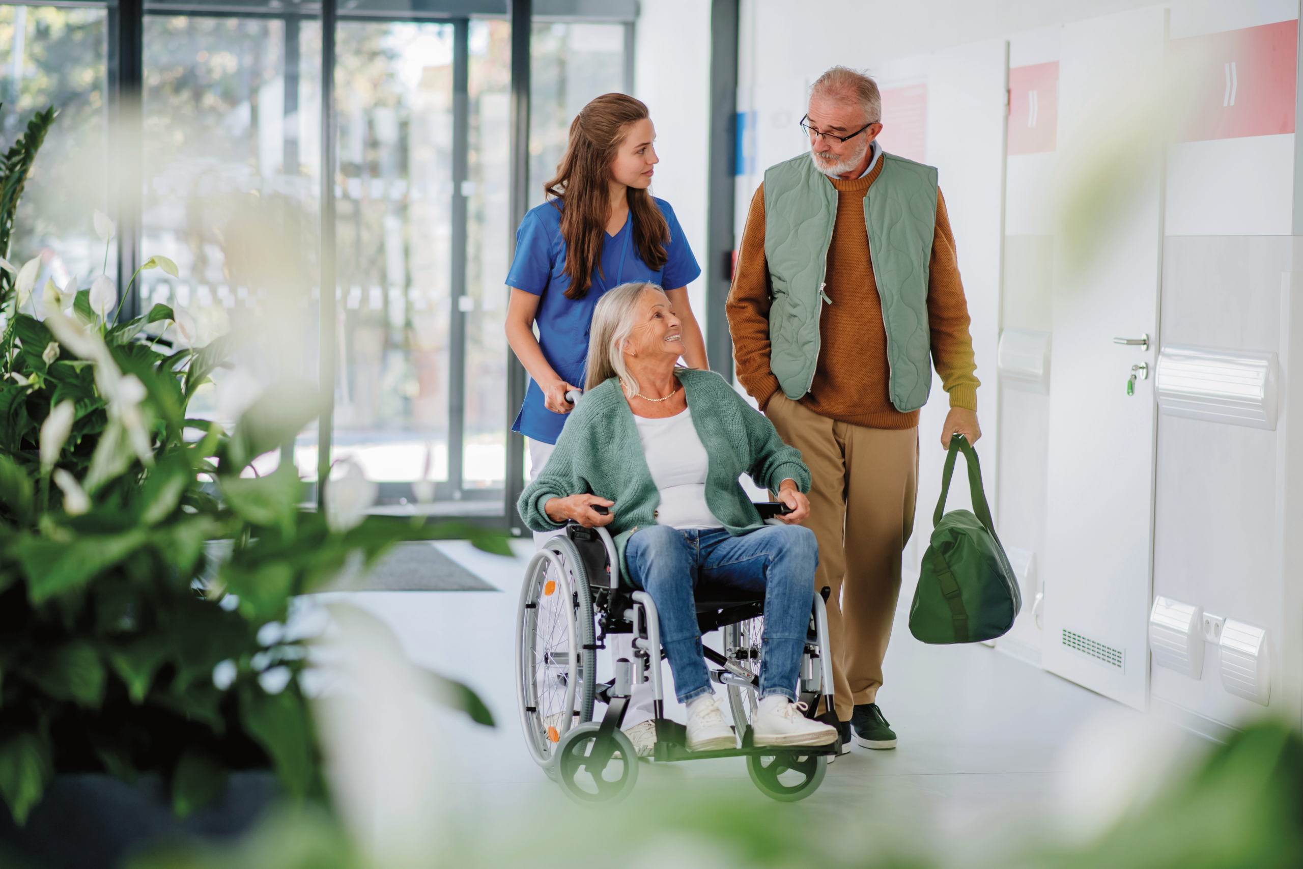 Care staff assisting a resident in a hallway