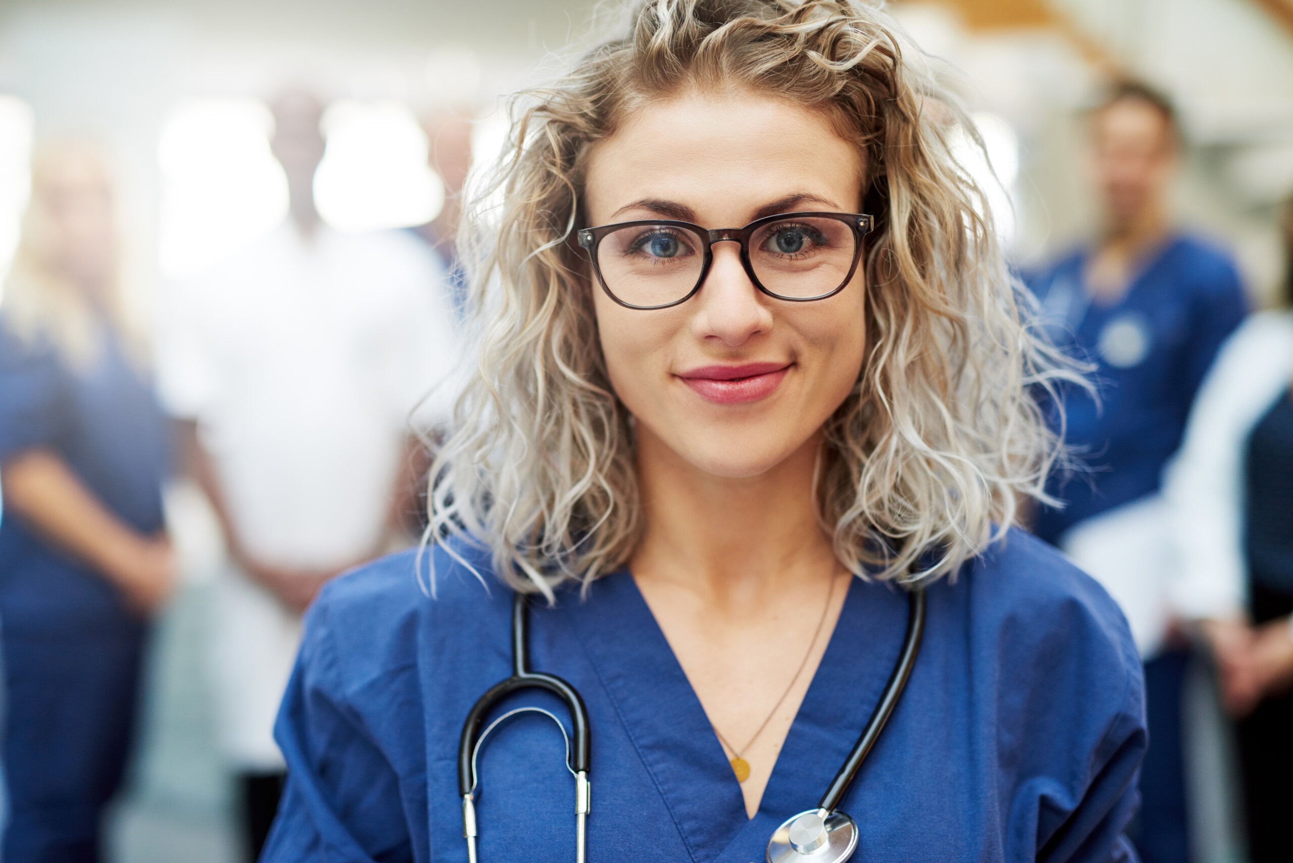 Nurse smiling in scrubs with a stethoscope