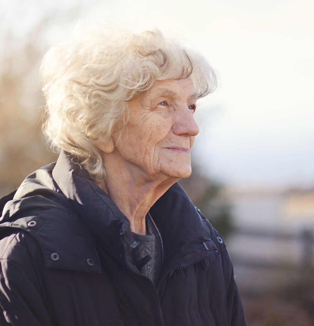 Elderly woman smiling outdoors