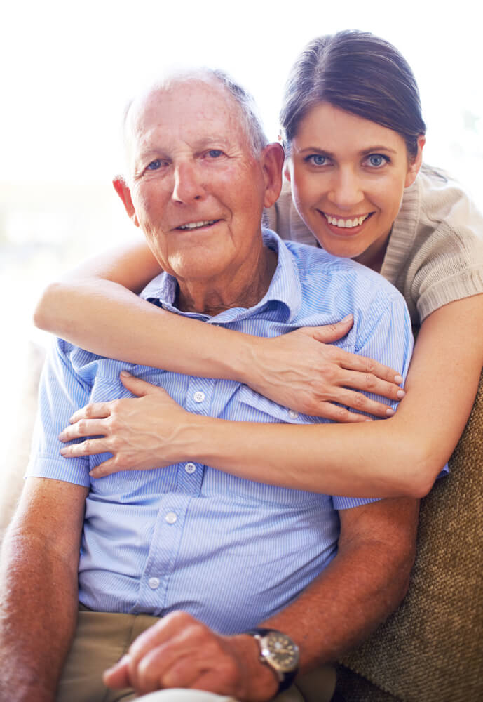 Older man with caregiver smiling together