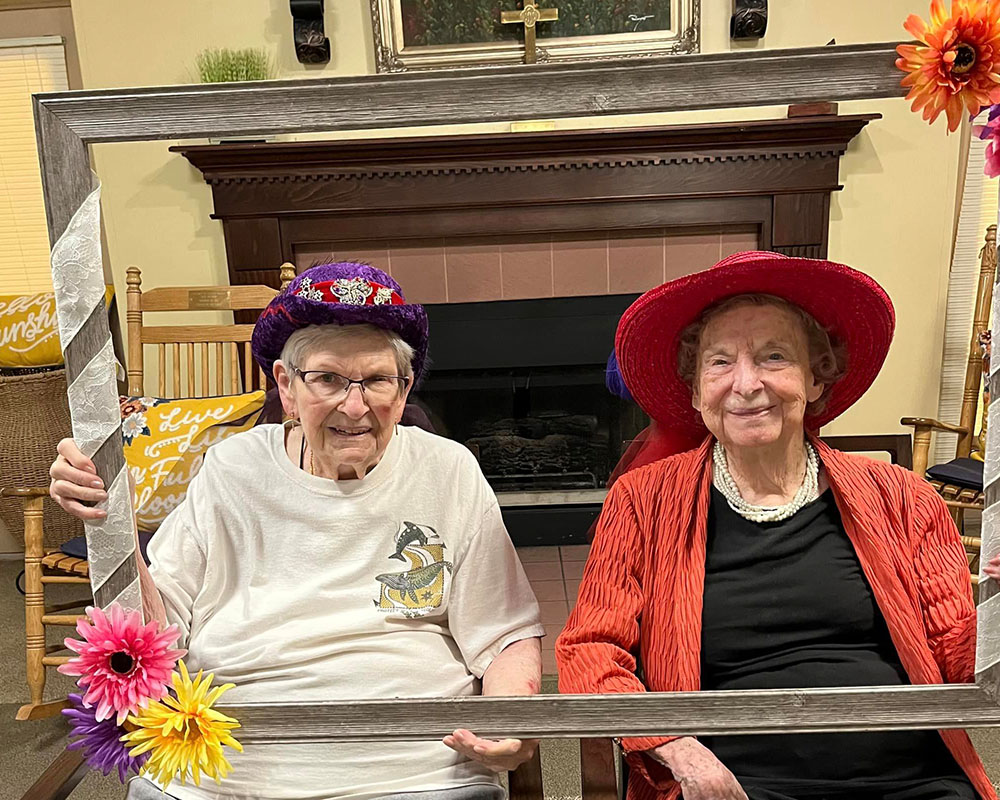 Two residents enjoying a festive indoor activity.