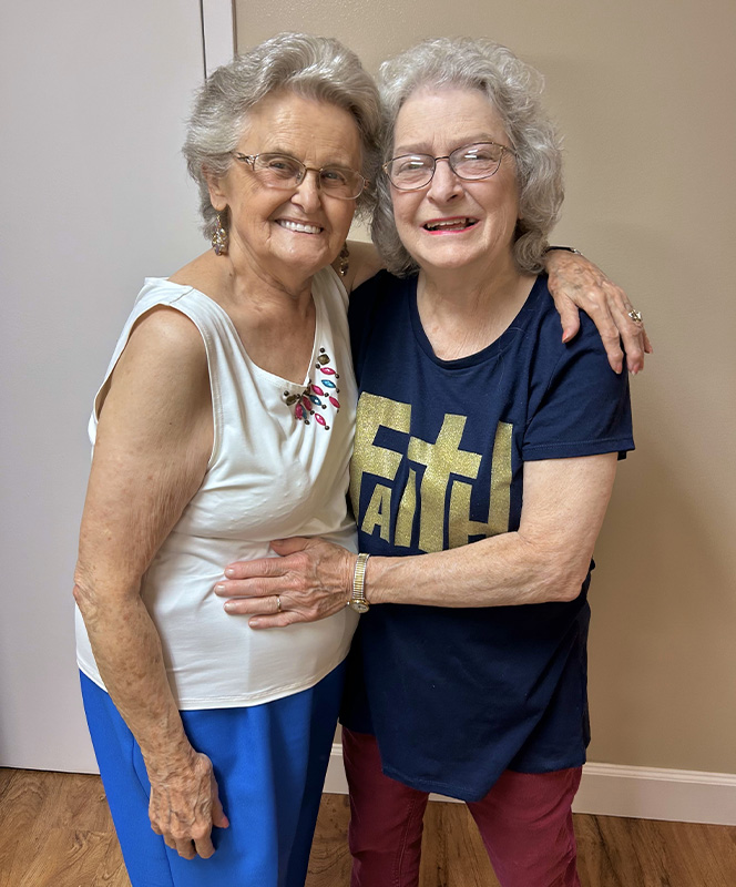 Two smiling residents enjoying each other's company