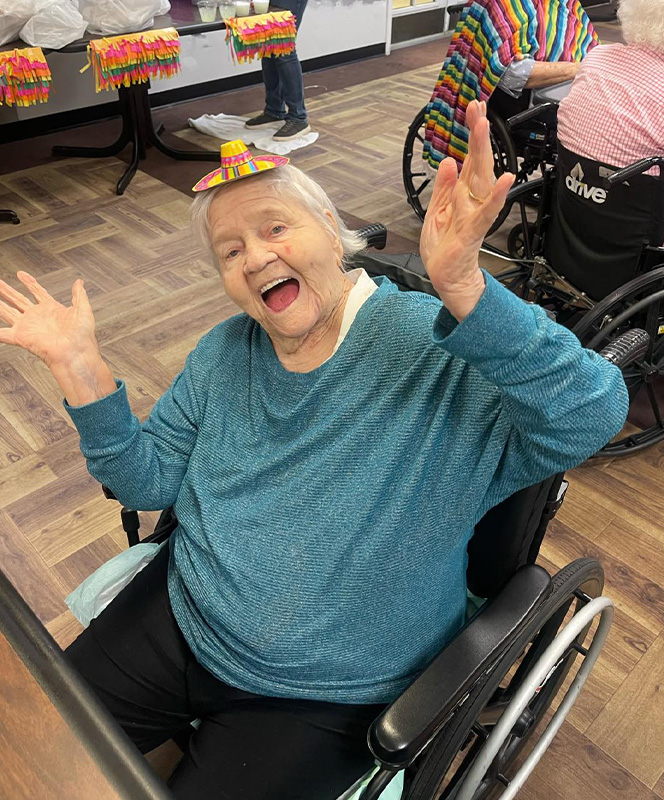 Elderly woman celebrating with a small hat.