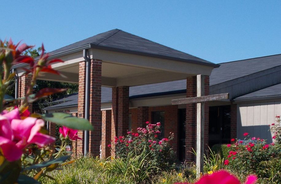 Exterior view of nursing home entrance with flowers