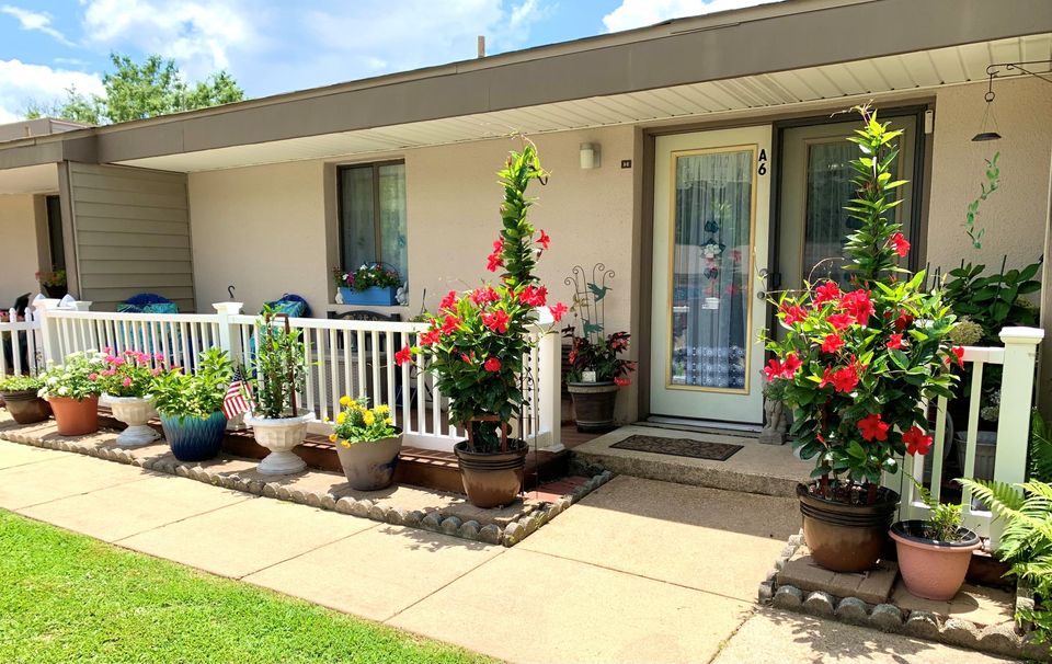 Welcoming entrance with flowers and a porch