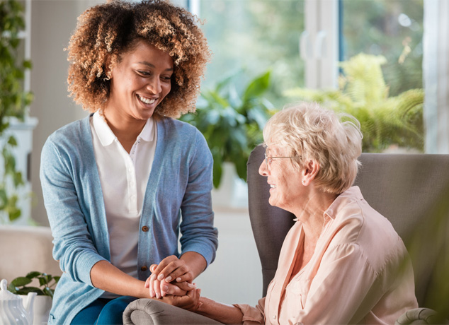 Caregiver interacting warmly with a senior resident.