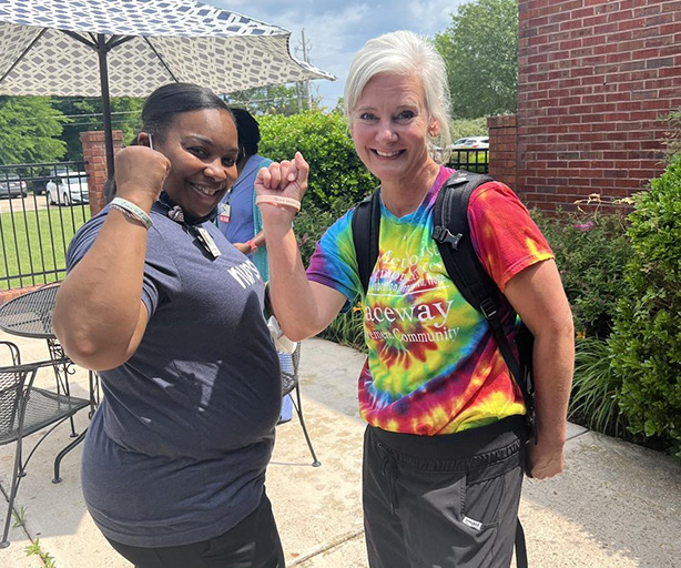 Two cheerful staff members outside enjoying the day.