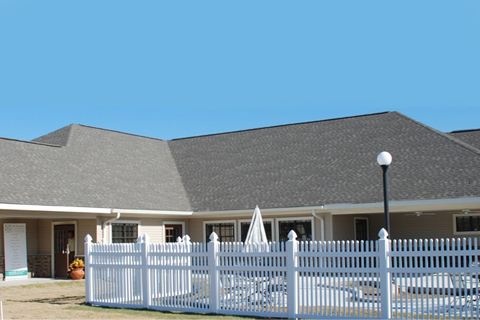 Exterior view of a building with a pool area.
