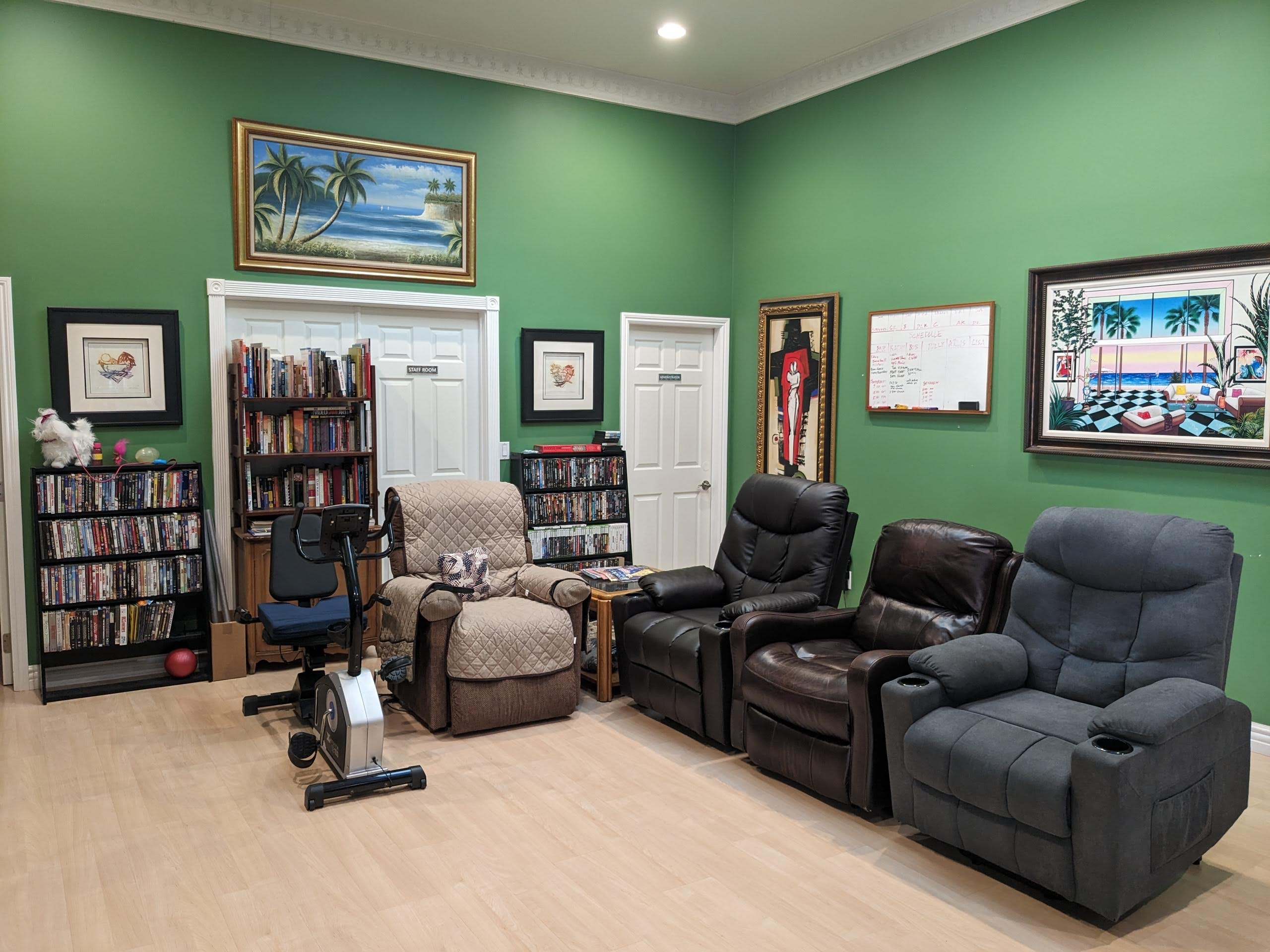 Cozy common area with recliners and bookshelves.