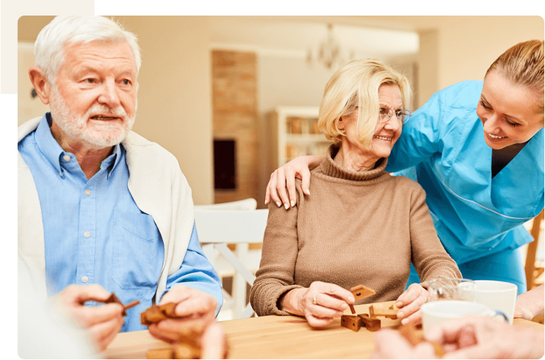 Residents engaging in a social activity with staff.