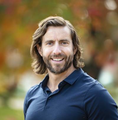 Smiling man with a beard outdoors