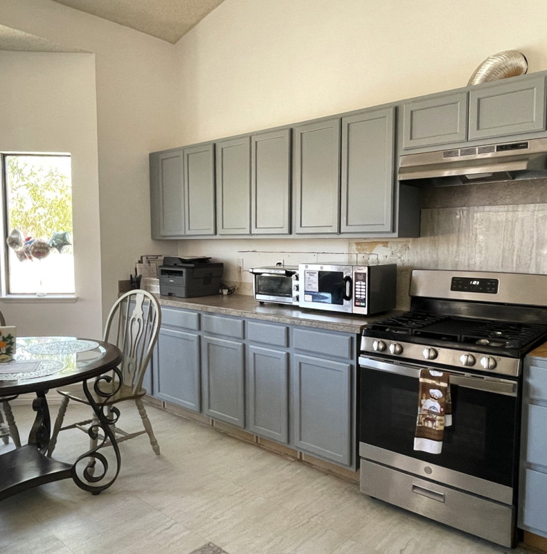 Modern kitchen with appliances and dining table.