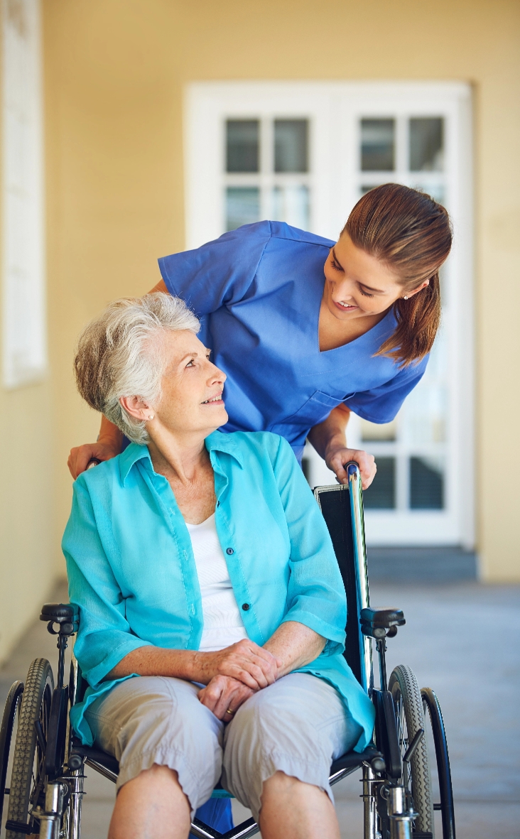 Caregiver interacting with a resident in a wheelchair