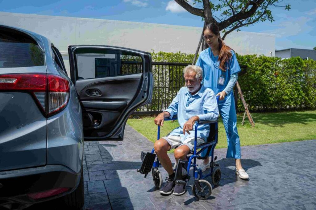 Caregiver assisting elderly man with wheelchair