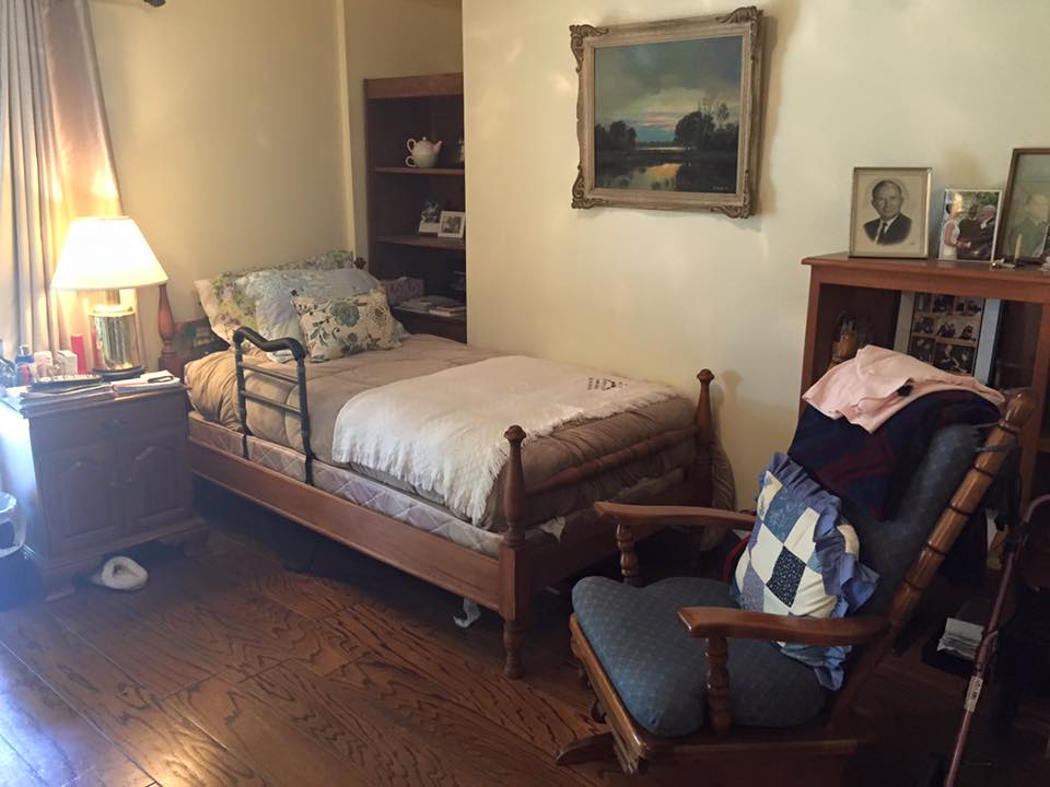 Private resident room with a bed and chair