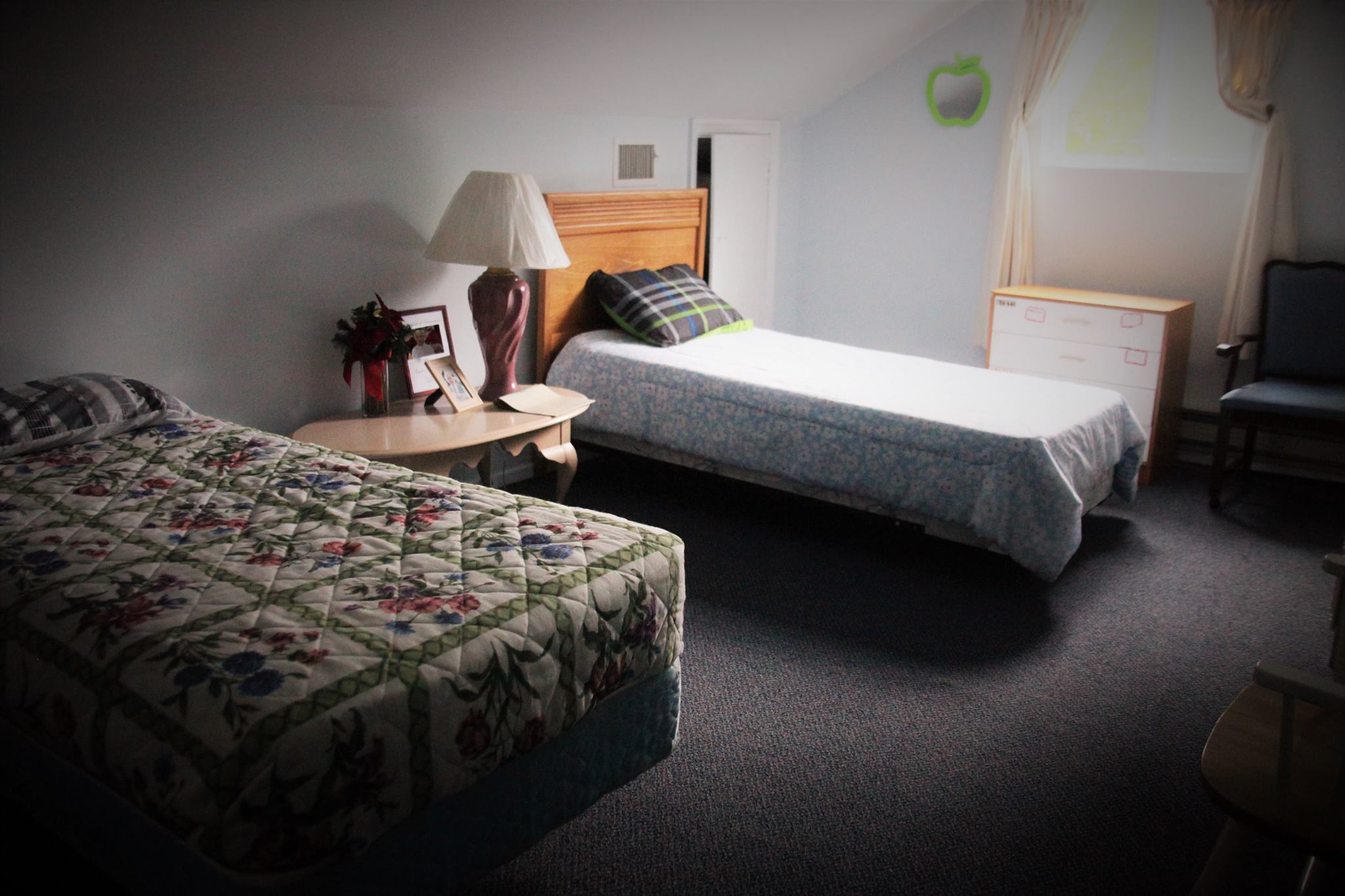 Cozy resident room with two beds and natural light