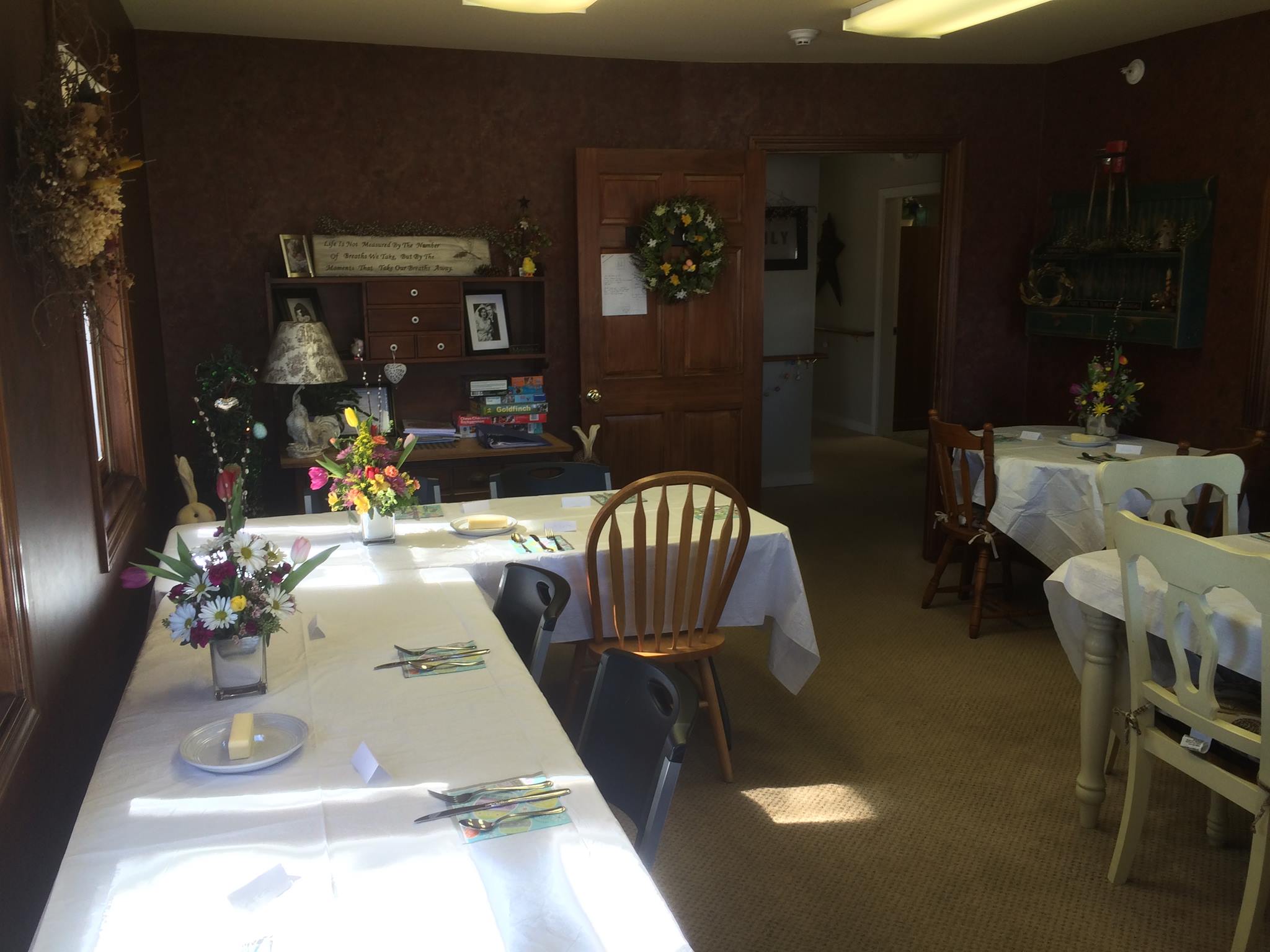 Cozy dining area set for a meal with flowers