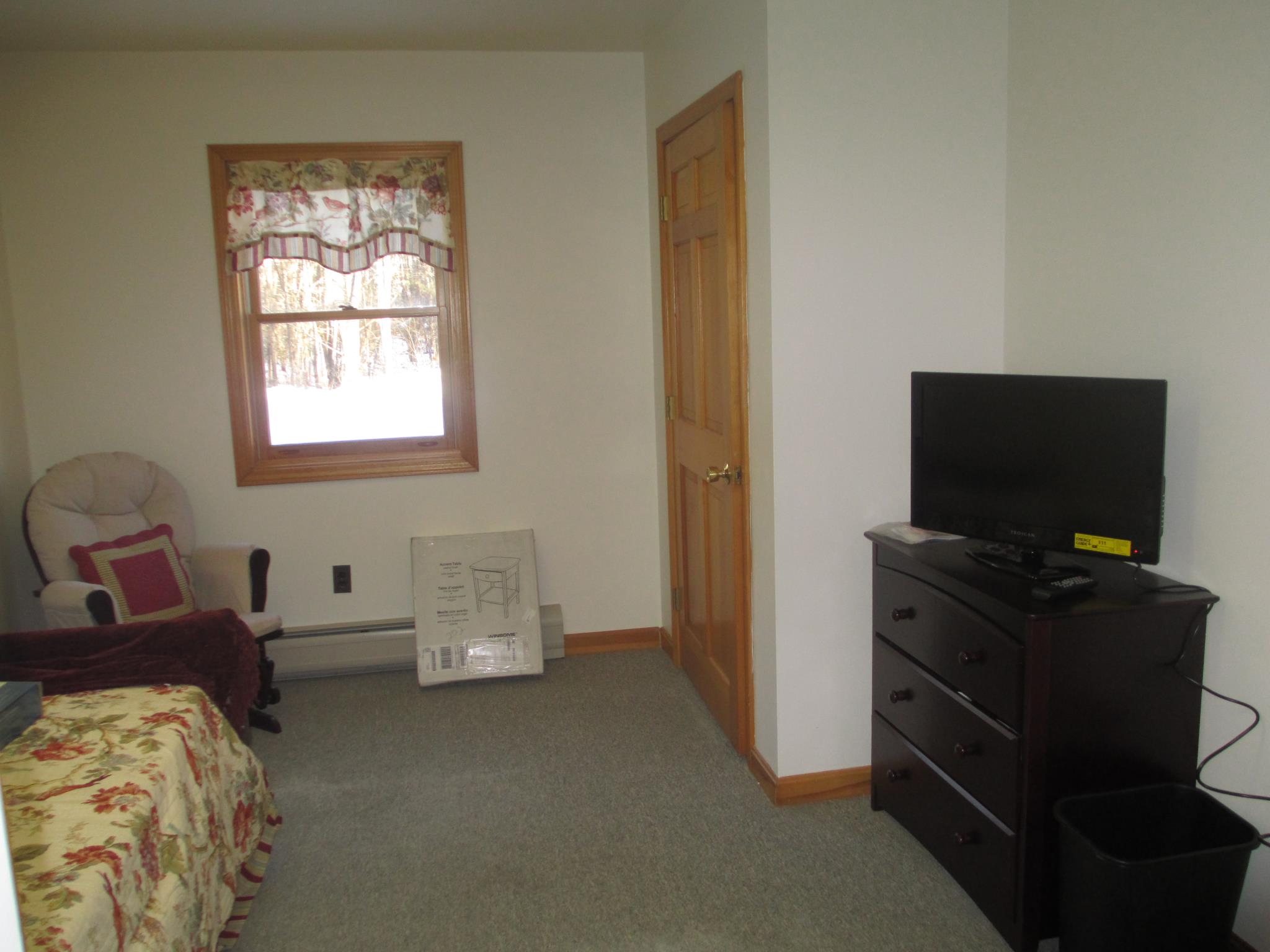 Cozy interior room with a bed and TV
