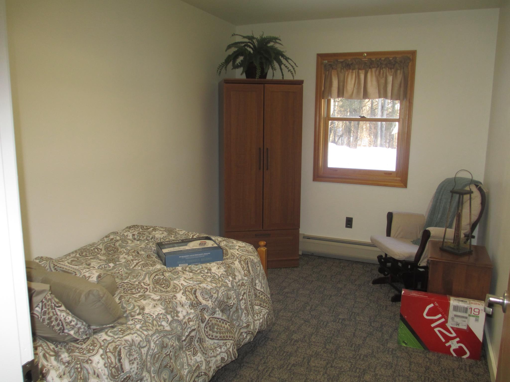 A private resident room with a bed and chair