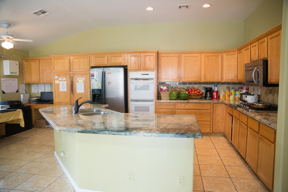 Bright kitchen area with fruits and appliances