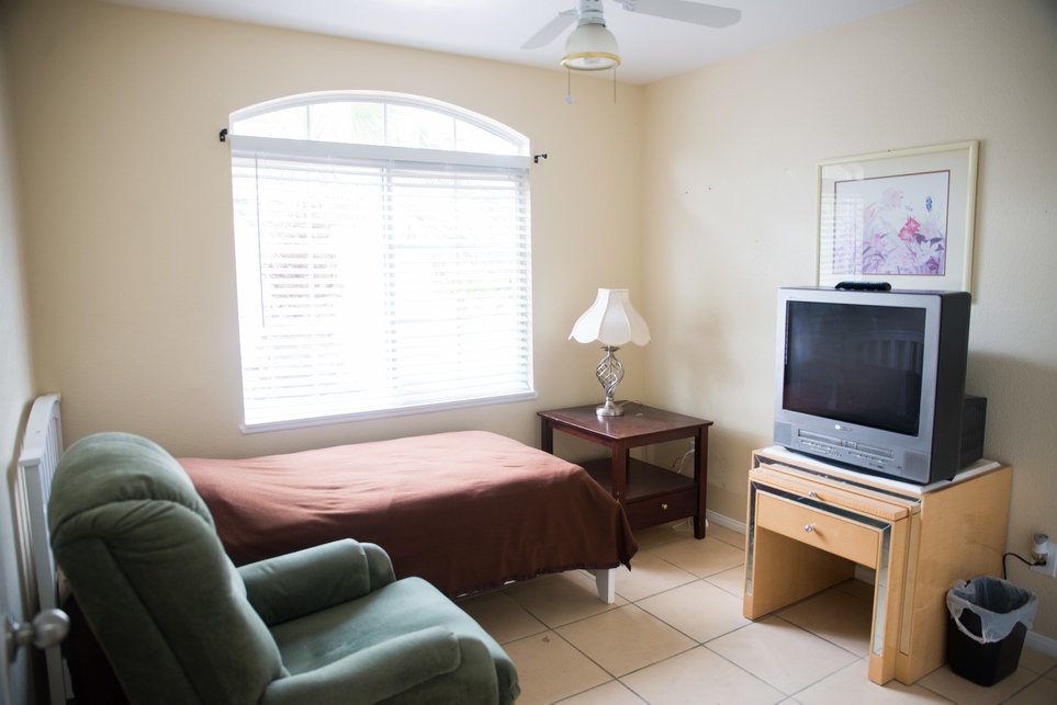 Bright private room with a bed and TV