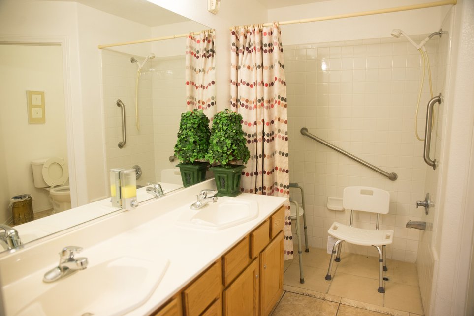 Accessible bathroom with grab bars and shower chair