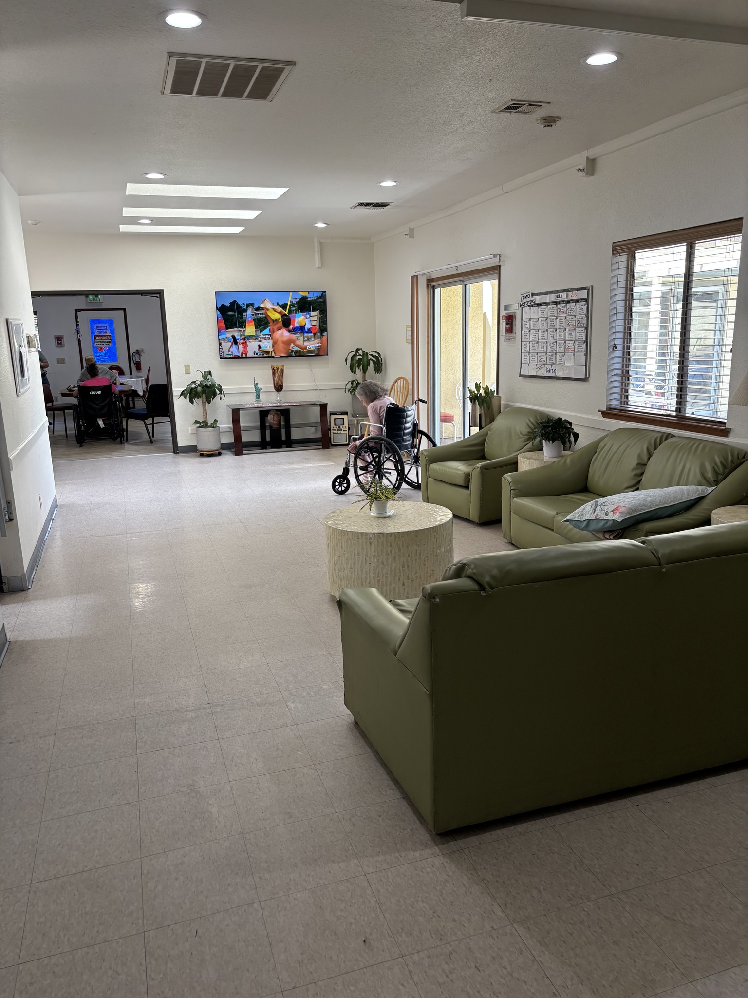 Interior of a common area with residents and seating