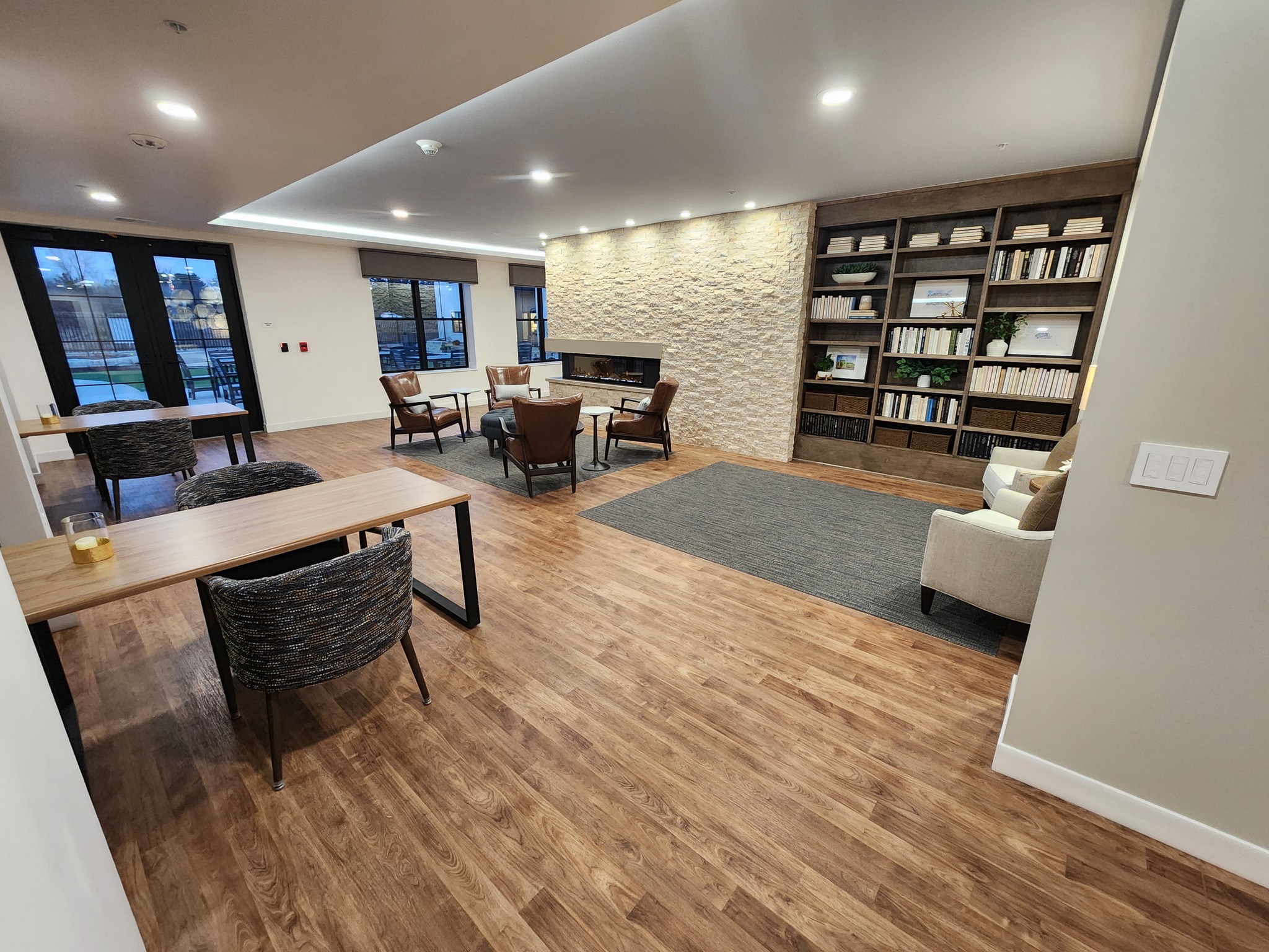 Bright common area with seating and bookshelves