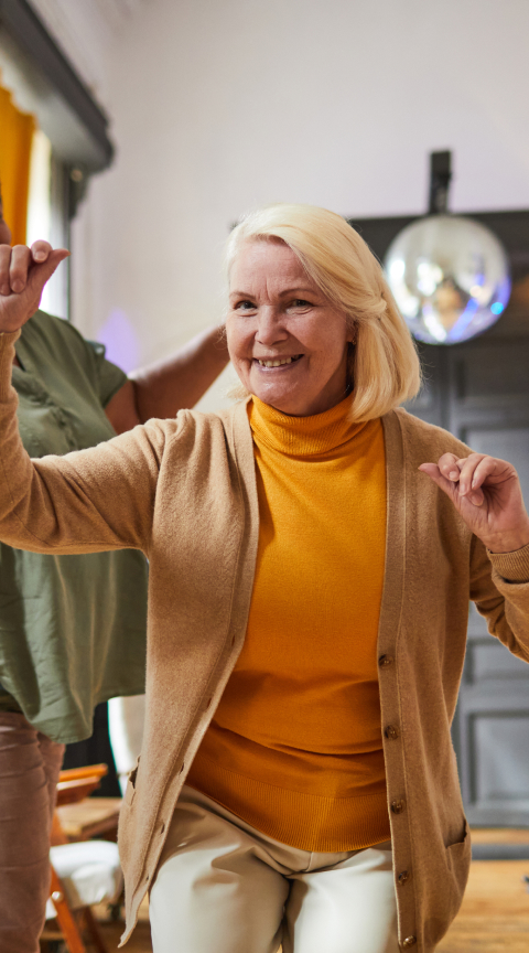 Resident actively engaging in a group activity indoors
