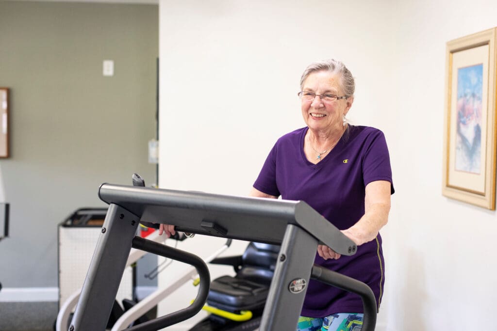 Senior resident using a treadmill in a fitness area