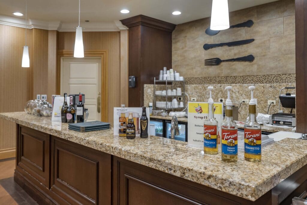 A well-appointed dining area with beverages on the counter