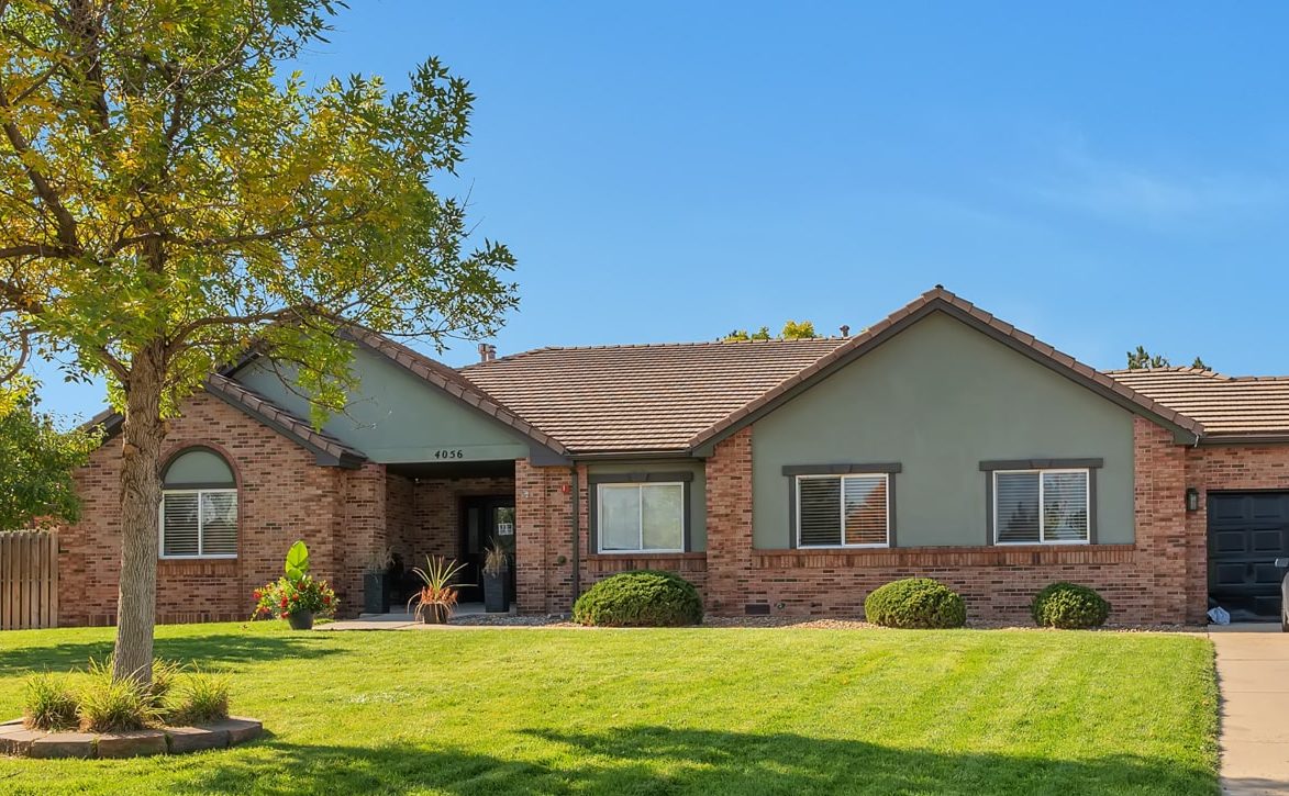 Exterior view of a senior living facility with landscaped yard