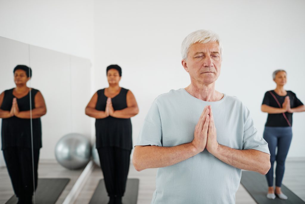 Residents participating in a yoga class indoors