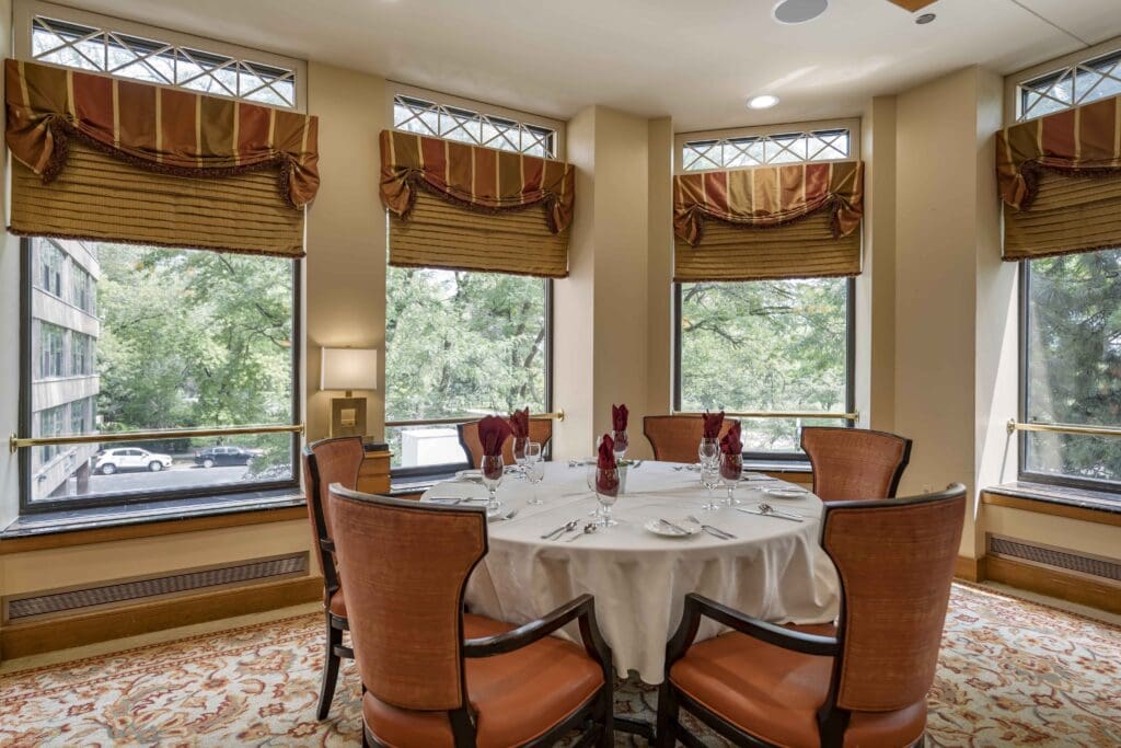 Dining room setup with view of outside trees