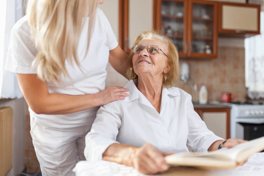 Caregiver interacting with elderly resident indoors