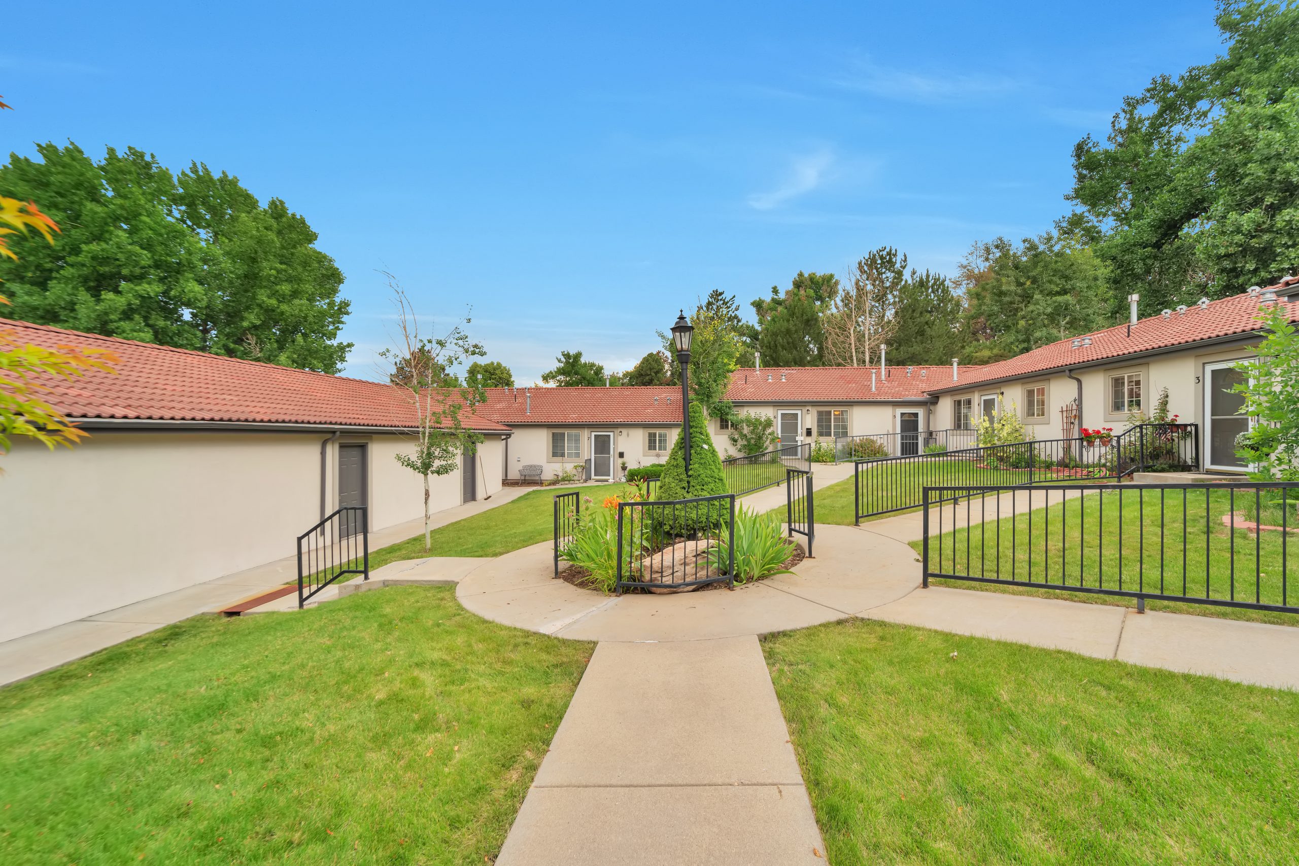 Outdoor pathway and landscaping at a senior living facility