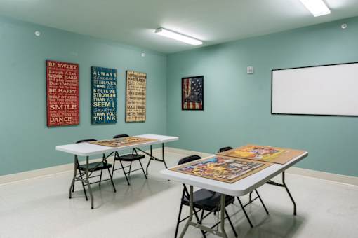 Interior activity room with tables and wall art
