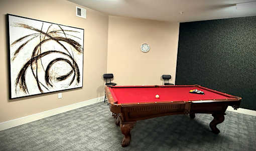 Interior room with a pool table and artwork